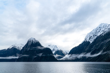 Mountains in Milford Sound with low and high cloud
