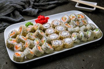 set of tempura rolls on black concrete table