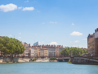 Fototapeta na wymiar Panorama of Saone river and the Quais de Saone riverbank and riverside in the city center of Lyon, with a focus on the old building facades of the Presqu'Ile, also called Peninsula