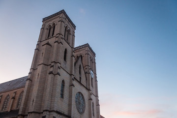 Fototapeta na wymiar Eglise Saint Jean Baptiste Church at dusk in Bourgoin Jallieu, France, a city of Dauphine region, in Isere Departement. It is the main catholic church of this city, built in the 19th century
