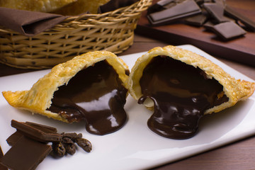 One open tradional Brazilian fried pastry called pastel stuffed with chocolate Brazilian dessert...