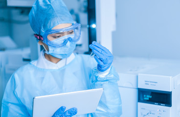 Female scientist looking at the scientific sample in the laboratory	
