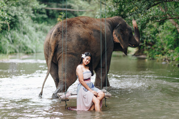 Portrait Asian woman enjoying with elephant 