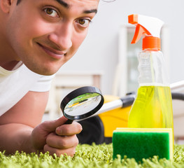 Young husband man cleaning floor at home