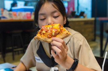 Asian children eat pizza