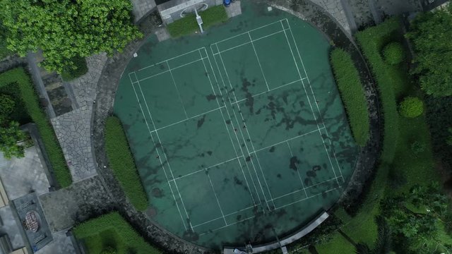 Top view reveal shot of Guagzhou downtown living block, wih badminton court and green gardens, Guangdong, China. Aerial shot