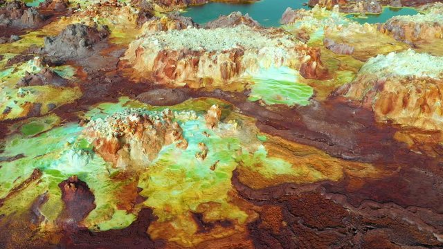 Rotating drone flight of volcanic sulfur fields of Dallol in the Danakil Depression, hot springs and acid mineral deposits in surreal landscape in Ethiopia, Africa