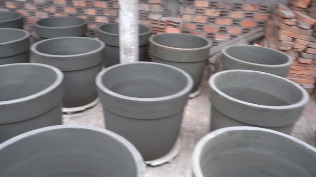 many clay pots and bowls drying in drying room