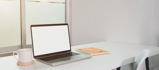 Open blank screen laptop computer with coffee cup