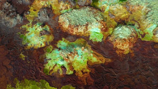 Ethiopia adventure travel - drone shot of vivid colorful sulfur ponds at Dallol volcano in the Danakil Depression, one of the hottest places on the planet