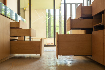 Opening wooden shelfs under installation inside the house under construction