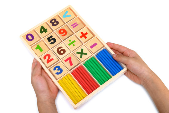 kid holding set of counting rods with number plates on white - Powered by Adobe