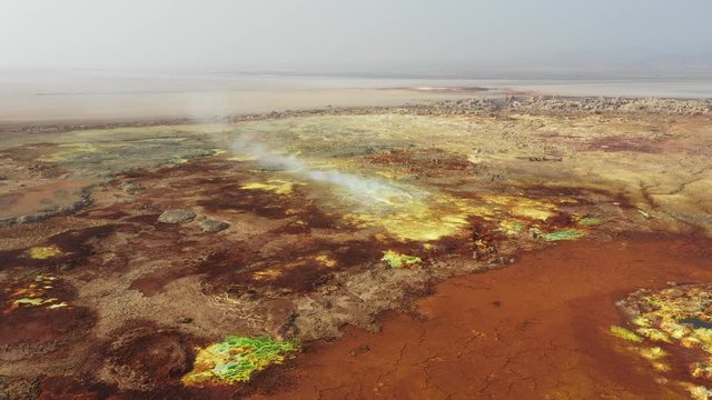 Aerial view of steaming sulfuric crater of Dallol hydrothermal field, bizarre natural scenery and geology in Ethiopia Africa