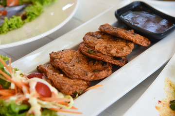 Fish Cake - paste balls  serv with fresh vegetable on white dish