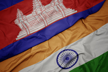 waving colorful flag of india and national flag of cambodia.