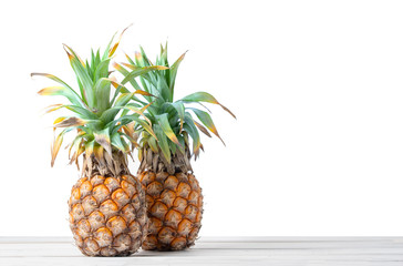 Pine Apple On Wooden Table With White Background.
