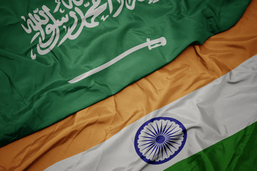 waving colorful flag of india and national flag of saudi arabia.