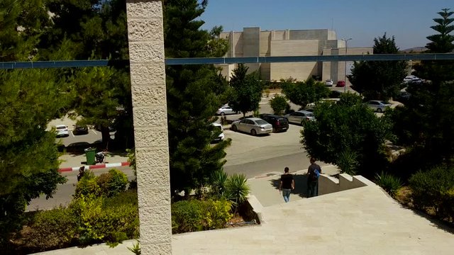 Time Lapse of walking people and cares moving in Birzeit university najjad zeenni. Afternoon time.