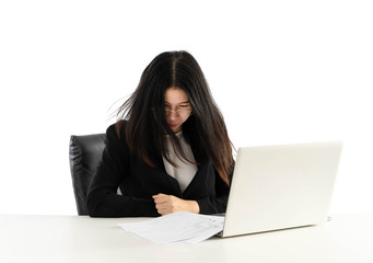 Woman wearing glasses and being stressed at work on her computer.