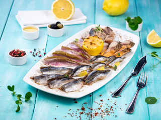 Fish plate. Assorted fish appetizers. Restaurant serving dishes.