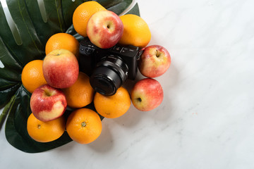 tropical fruits apple and orange with marble background