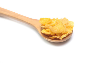 Cornflakes on spoon wood isolated on white background