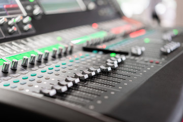 Fototapeta na wymiar Sound mixer. Professional audio mixing console with lights, buttons, faders and sliders.
