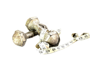 Metal dumbbells and waist measurements on a white background