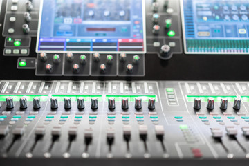 od adjusters and red buttons of a mixing console. It is used for audio signals modifications to achieve the desired output. Applied in recording studios, broadcasting, television.