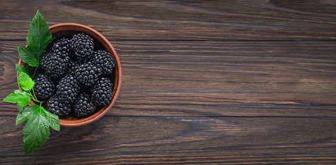 Close-up blackberry in a  wooden bowl. View from above