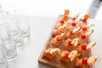 Delicious shrimp and sliced tomatoes. Tasty buffet table. Catering concept