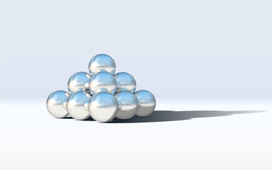 Chrome metal balls in pyramid stack with abstract calm and relaxing background