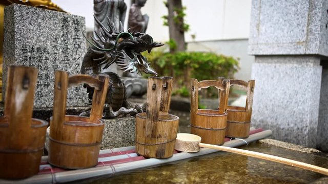 4K, Japanese water ablution pavilion for a ceremonial purification rite known as Temizu at Shinto temple in Japan sanctuary. Japanese syncretism.-Dan