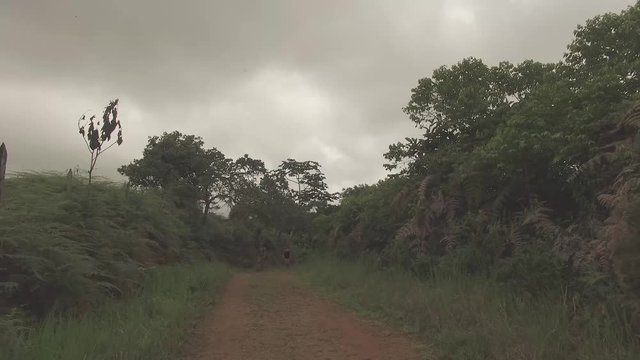 Man and woman taking a hike in Costa Rica along a mountain ridgel.