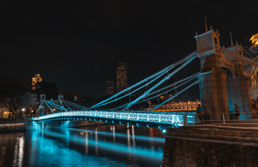 Fototapeta na wymiar SINGAPORE - MAY 19, 2019: Cavenagh Bridge one of the oldest bridges in Singapore, that spans across the Singapore River in the Downtown by night.