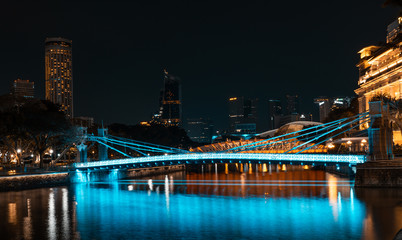 Fototapeta na wymiar SINGAPORE - MAY 19, 2019: Cavenagh Bridge one of the oldest bridges in Singapore, that spans across the Singapore River in the Downtown by night.