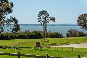 An old windmill stands tall against the test of time on a farm that overlooks the sea on Churchill...