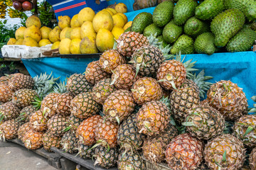 Pineapple, grapefruit and soursop fruit for sale at outdoor market