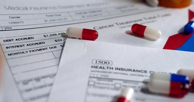 Prescription drug bottles and pills on a medical health care insurance form SLIDE RIGHT.