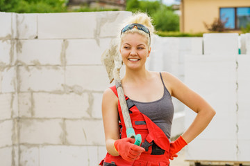 Woman using shovel on constriction site