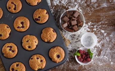 Delicious flavored cupcake with raspberries, white cream, and chocolate icing.