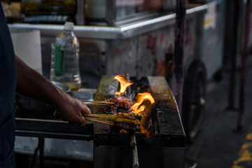 Cooking Satay on charcoal stove.