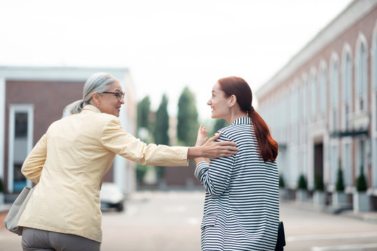 Businesswoman patting her young colleague on the shoulder