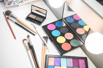 Beauty tools palettes collection. Brush on white table