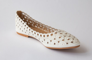 White with embroidered ballet flats. On a white background