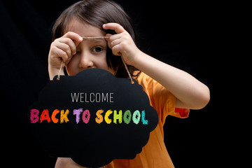 Little boy holding an empty advertising sign board in hand