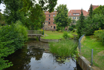 Fototapeta na wymiar Watermill garden with small river in Templin, Germany