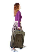 back view of walking woman with suitcase.