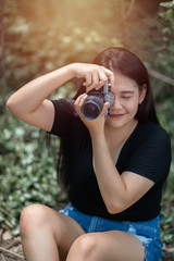 Portrait of asian woman is a professional photographer with mirrorless camera, outdoor portrait, free from copy space.