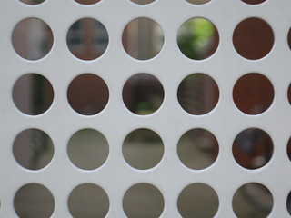 pattern of holes in a light gray iron plate